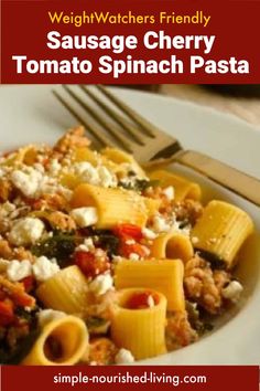 a white plate topped with pasta and spinach