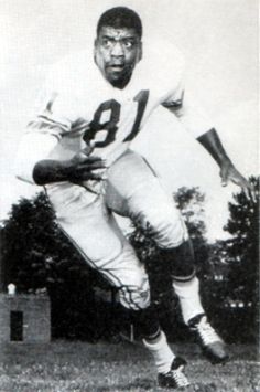 an old black and white photo of a football player