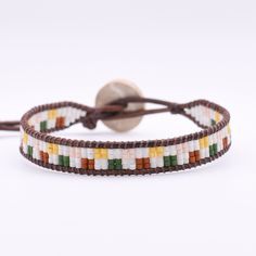 This single wrap leather bracelet is adjustable and has a second loop allowing some extra length.  Size: Adjustable from approx. 6.5-7in              >First Loop at approx. 6.5inches              >Second Loop at approx. 7inches Beads: Glass Seed Beads              >Matte White/Orange/Green/Pink/Yellow   Clasp: Coconut Button               >Brown Leather: Round Leather Cord              >Brown Thread: Nylon Upholstery Thread              >Brown *Photos are taken with care to ensure the color is portrayed correctly. However, due to different screen resolution, screen brightness, lighting, etc... from phone screens to computer screens, colors in the bracelet may differ slightly than pictured. If you have any questions, please don't hesitate to message me. Adjustable Colorful Beads Wrap Bracelet, Trendy Adjustable Wrap Bracelet With Colorful Beads, Adjustable Hand Wrapped Leather Wrap Bracelet, Trendy Adjustable Multicolor Wrap Bracelet, Adjustable Multicolor Wrap Bracelet With Round Beads, Multicolor Adjustable Wrap Bracelet With Round Beads, Multicolor Beaded Leather Bracelets, Multicolor Leather Beaded Bracelets Handmade, Adjustable Hand Wrapped Leather Bracelet With Round Beads