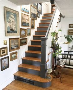 a staircase with pictures on the wall above it