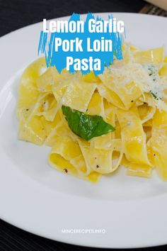 lemon garlic pork loin pasta on a white plate with parmesan cheese and basil