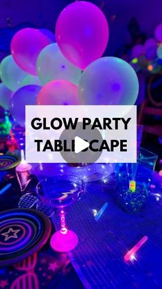 the glow party table is set up with balloons