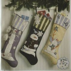 three christmas stockings hanging on a wall