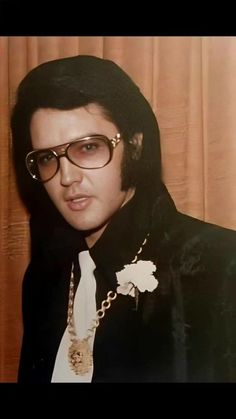 elvis presley wearing glasses and a black jacket