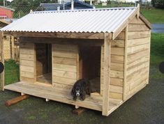 a dog house made out of wood with a metal roof