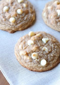 four cookies with white chocolate chips on top