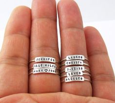 "The listing is for 1 ring. This dainty, personalized ring is a perfect gift for wife, mom, and grandma. The letters are hand stamped with any name, date, inspiration, and motivation word. The letters are tiny, yet very readable, on this petite and dainty ring. Each ring is small enough that many rings can be stacked on a single finger. [ Material ] The band is Argentium silver and the nameplate is sterling silver. Argentium silver is a high quality sterling silver with tarnish-resistant attribu Date Inspiration, Personalized Stackable Rings, Birthday Mother, Family Rings, Name Rings, Personalized Rings, Stackable Ring, Stamped Jewelry, Unique Engagement Rings