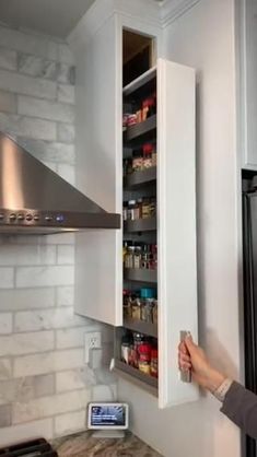 a woman is opening the refrigerator door to reveal what it's really like in her kitchen