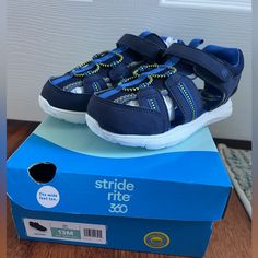 New In Box. Size 13. Blue And Navy. Blue Adjustable Non-slip Sandals, Adjustable Non-slip Blue Sandals, Closed Toe Sneakers For Playtime, Summer Playtime Sneakers With Closed Toe, Sporty Blue Sandals With Removable Insole, Blue Closed Toe Sandals For Playtime, Blue Sandals With Soft Sole For Playtime, Sporty Blue Flat Sandals, Blue Sandals With Soft Sole For Spring