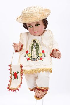 a doll with a white shirt and hat holding a small bag in one hand while standing on a stool