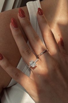 a woman's hand with two rings on it