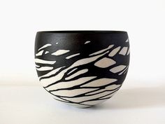 a black and white vase with zebra stripes on it