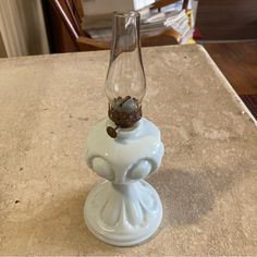 a glass vase sitting on top of a table