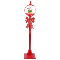 a red and white christmas decoration with mickey mouse on it's head, sitting on top of a pole