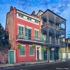 an old red building with balconies on the second story