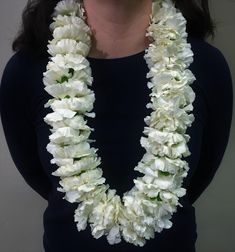 a woman wearing a white flower lei