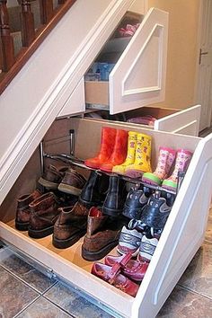 an under the stairs shoe rack holds many pairs of shoes