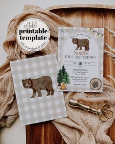 the bear themed birthday party is set up on a wooden table with items such as cards, scissors and twine