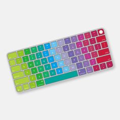 the colorful keyboard is sitting on top of the white surface, and it appears to be in color