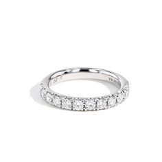 a white gold wedding band with five round diamonds on the sides and four rows of small stones