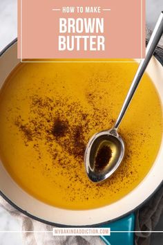 a bowl filled with brown butter next to a spoon