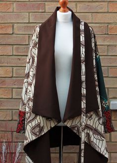 A unique three African print jacket. This stylish jacket is loose fitting, fully lined to keep you warm and very comfortable  Jacket has no closure( Belt included), big raglan long sleeves and waterfall collar. Available in 5 sizes  SMALL- (8-10) uk sizes  MEDIUM- (12-14)  LARGE (16-18)   X-LARGE (20-22)   XX-LARGE (24-26)   Can be made in other prints please enquire to see what prints we have in stock. African Print Jacket Dress, Casual Batik Print Outerwear For Fall, Patterned Patchwork Outerwear For Fall, Printed Long Sleeve Outerwear For Fall, Winter Outerwear With Patchwork And Kimono Sleeves, Casual Long Sleeve Outerwear With Batik Print, Patterned Printed Winter Outerwear, Ankara Coats For Ladies, Winter Patterned Printed Outerwear