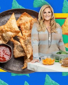 a woman standing in front of a tray with food on it and an assortment of other foods