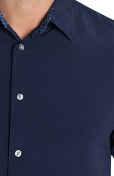 A crisp construction offers easy comfort to this short-sleeve button-up shirt that's great for work or play. Front button closure Spread collar Short sleeves 91% polyester, 9% spandex Machine wash, dry flat Imported Classic Short Sleeve Button-up Shirt With Snap Buttons, Solid Color Shirt With Button Closure And Spread Collar, Shirt With Button Closure And Spread Collar, Solid Shirt With Spread Collar And Button Closure, Solid Color Button-up Dress Shirt, Modern Short Sleeve Shirt For Work With Button Closure, Solid Color Collared Dress Shirt With Button Closure, Solid Color Collared Shirt With Functional Buttons, Solid Collared Dress Shirt With Button Closure