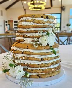 a wedding cake made out of cookies and white flowers