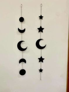 three metal stars and crescents hanging on a wall