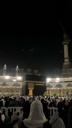 the ka'bah at night with many people around it