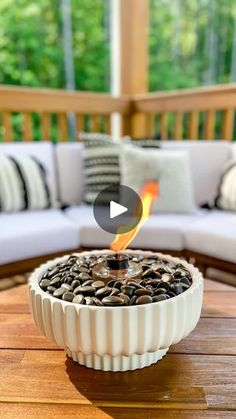 a fire pit sitting on top of a wooden table