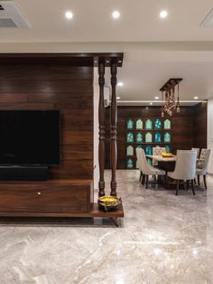 a living room filled with furniture and a flat screen tv on top of a wooden stand