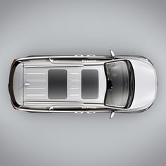 an overhead view of a silver car on a gray background