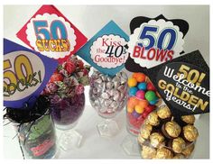 a table topped with lots of candy and candies next to signs that say 50 cents