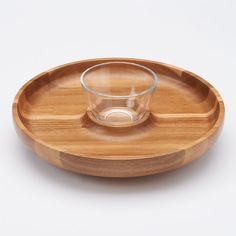 a wooden plate with a glass on it