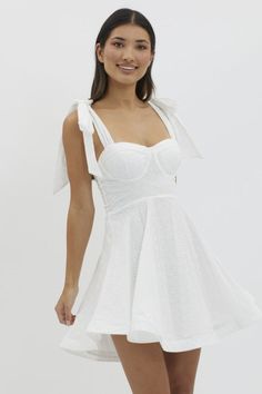 Stunning details in this chic and trendy dress perfect for Summer, Brides, Graduations, Bachelorette Parties, White Parties, vacations, and so much more! Our Follow Your Dreams White Mini Dress features a fit and flare skirt, self tie bow straps, eyelet details, corset top, padded bust, back zipper, and is fully lined. 100% Cotton. Model Measurements: Height 5'5", Bust 33", Waist 25", Hips 33" wearing a size Small. White Parties, Bow Straps, Fit And Flare Skirt, Follow Your Dreams, Style Steal, Trendy Dress, Outerwear Vest, Tie Bow, Bachelorette Parties