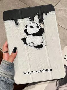 a person holding an ipad case with a panda bear drawn on the front and side