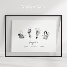 a black and white photo with three baby's handprints in the frame