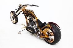 a gold and black motorcycle is shown on a white background