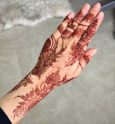 a woman's hand with henna on it