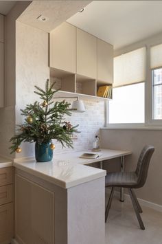 a kitchen with a plant on the island in front of it and a chair next to it