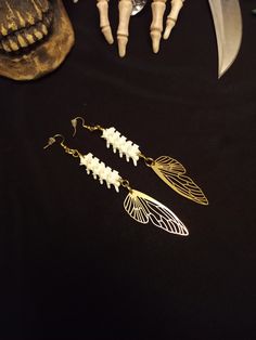 Here is a Nice Pair of Rattlesnake Vertebrae Fairy Wing Bone earrings! Each Pair is Made with 12 Real Rattlesnake Vertebrae, and 2 Gorgeous Gold Fairy Wing Pendants. These Earrings are 6 Inches Long. All Items Ship Within 1-3 Days via USPS First Class Service. Shipping on These Earrings is Free! ( USA Only ) All Bone Jewelry Orders Over 35 USD $ Ship for FREE. International Shipping Will Be 16.00, Australia 18.00 And All Additional Items Add 1.00 to the Shipping Cost. International Shipping May Vertebrae Jewelry, Bone Fairy, Vertebrae Earrings, Real Bone Jewelry, Animal Bone Jewelry, Wiccan Earrings, Fairy Wing Earrings, Wiccan Necklace, Anklet Tattoos