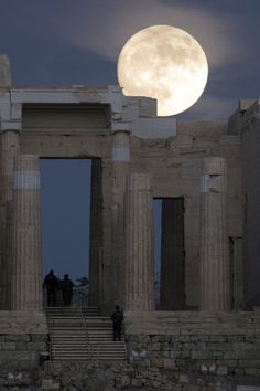 the full moon is seen over part of the acrobatic temple