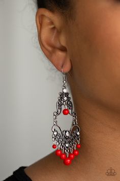 Infused with hints of glittery white rhinestones, dotted silver filigree swirls into a decorative frame. Polished red beads swing from the bottom and top of the ornate frame, adding colorful movement to the whimsical piece. Earring attaches to a standard fishhook fitting.

Sold as one pair of earrings. Decorative Frame, Red Beads, Fish Hook Earrings, Ornate Frame, Paparazzi Accessories, Red Earrings, White Rhinestone, Red Rhinestone, Beaded Fringe