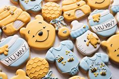 winnie the pooh cookies are decorated with royal icing and honey combs on them