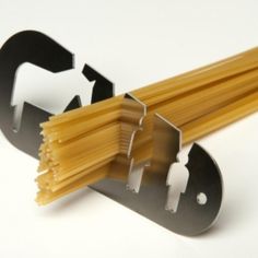 a pair of scissors and some pasta on a white surface with the handles extended up