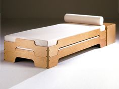 the bed frame is made out of wood and has a mattress on top of it