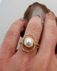 ES2056 Vintage pearl 14k gold ring. 14k yellow gold ring with interlocking circles design set with genuine 8mm white pearl. Hallmark: 14k. Height: 11.8mm. Diameter of circles: 15mmx12mm. Ring size: 6, can be resized, please inquire. This is very fun and playful ring. Modern Yellow Gold Pearl Ring For Anniversary, Modern Yellow Gold Pearl Ring For Formal Occasions, Modern Round Pearl Ring In Yellow Gold, Modern 14k Gold Pearl Open Ring, Oval Gold Pearl Ring, Elegant Gold Oval Bypass Ring, Modern 14k Yellow Gold Pearl Ring, Modern Oval Pearl Ring For Anniversary, Modern 14k Gold Pearl Ring For Wedding