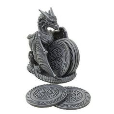 a dragon figurine sitting on top of two coasters